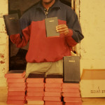 Bro Makona display bibles to be given to poor pastors in Africa.